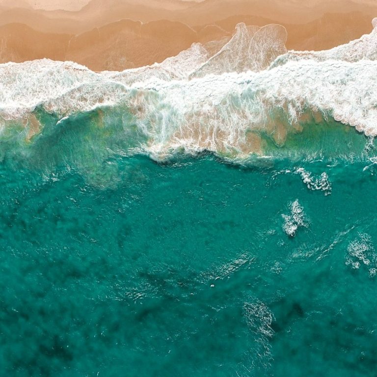 sand on the beach and the waves of the ocean